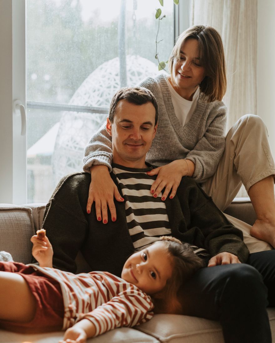 A family relaxing together on the couch at home